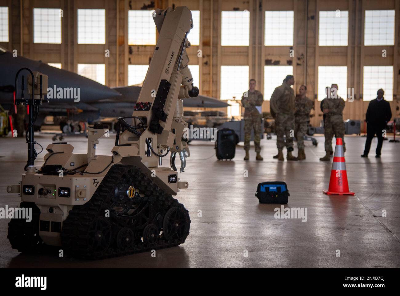 Team Eglin members watch an Explosive Ordnance Disposal's (EOD) demonstration of counter IED