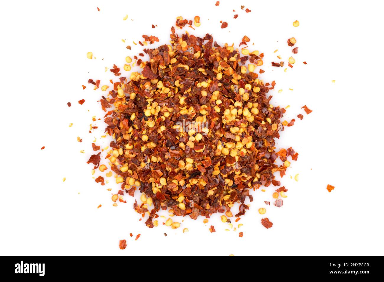 The pile of a crushed red pepper, dried chili flakes and seeds isolated