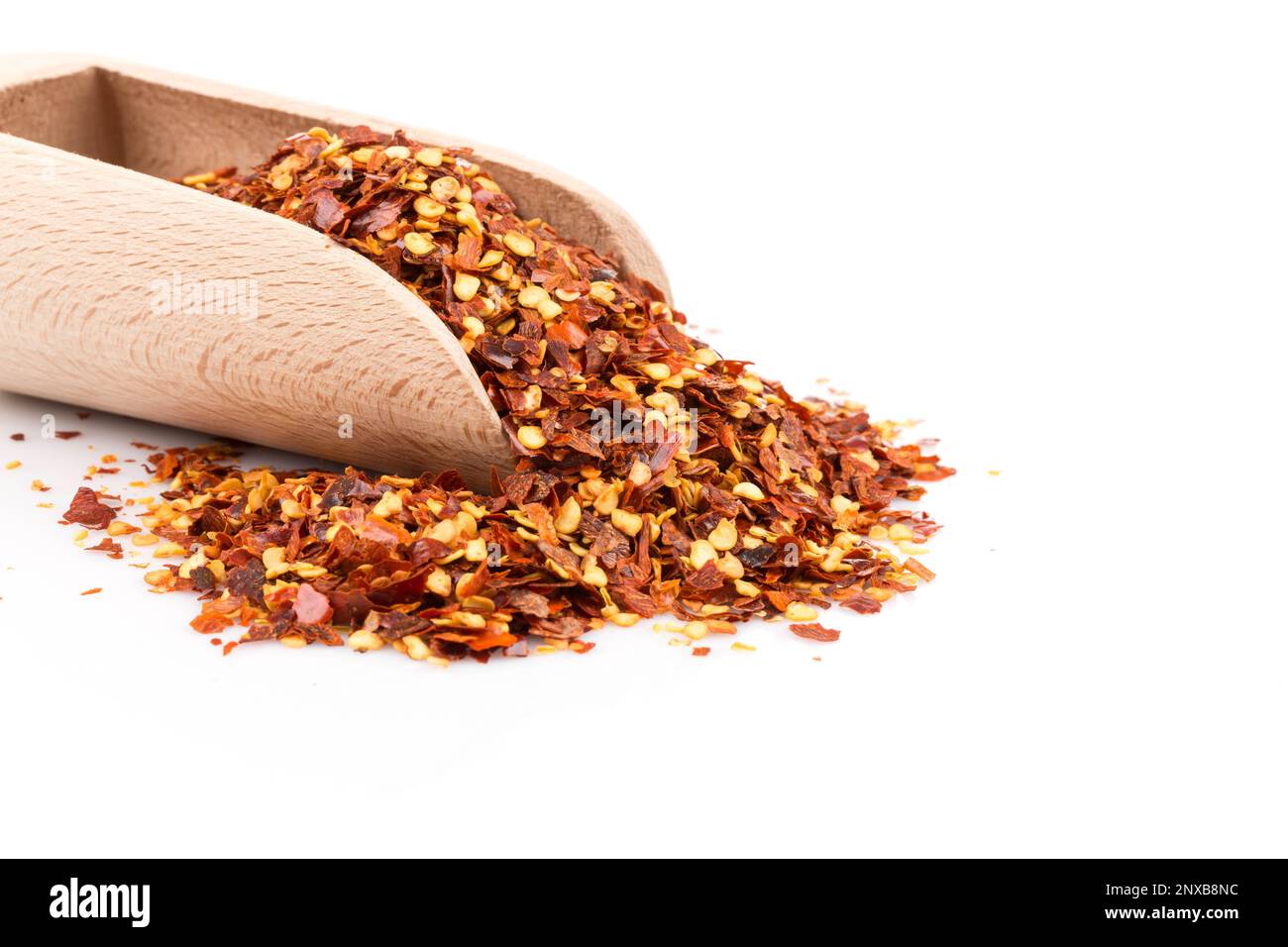 The pile of a crushed red pepper, dried chili flakes and seeds isolated