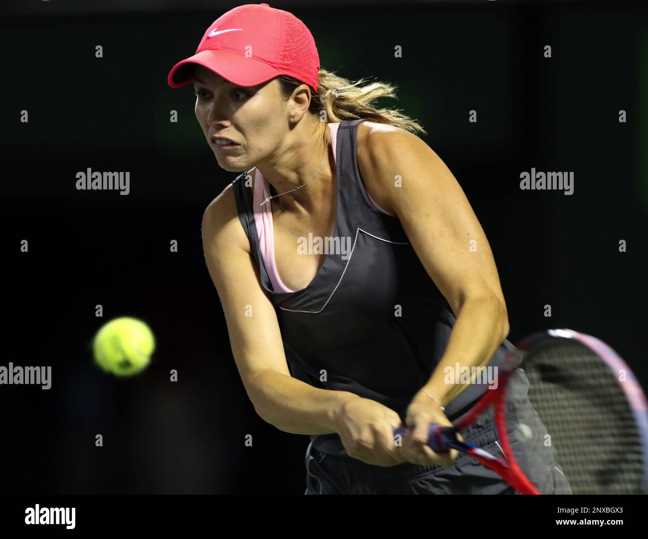 March 28, 2018: Danielle Collins of the United States hits a backhand  against Venus Williams of the United States during a quarterfinal at the 2018  Miami Open presented by Itau professional tennis
