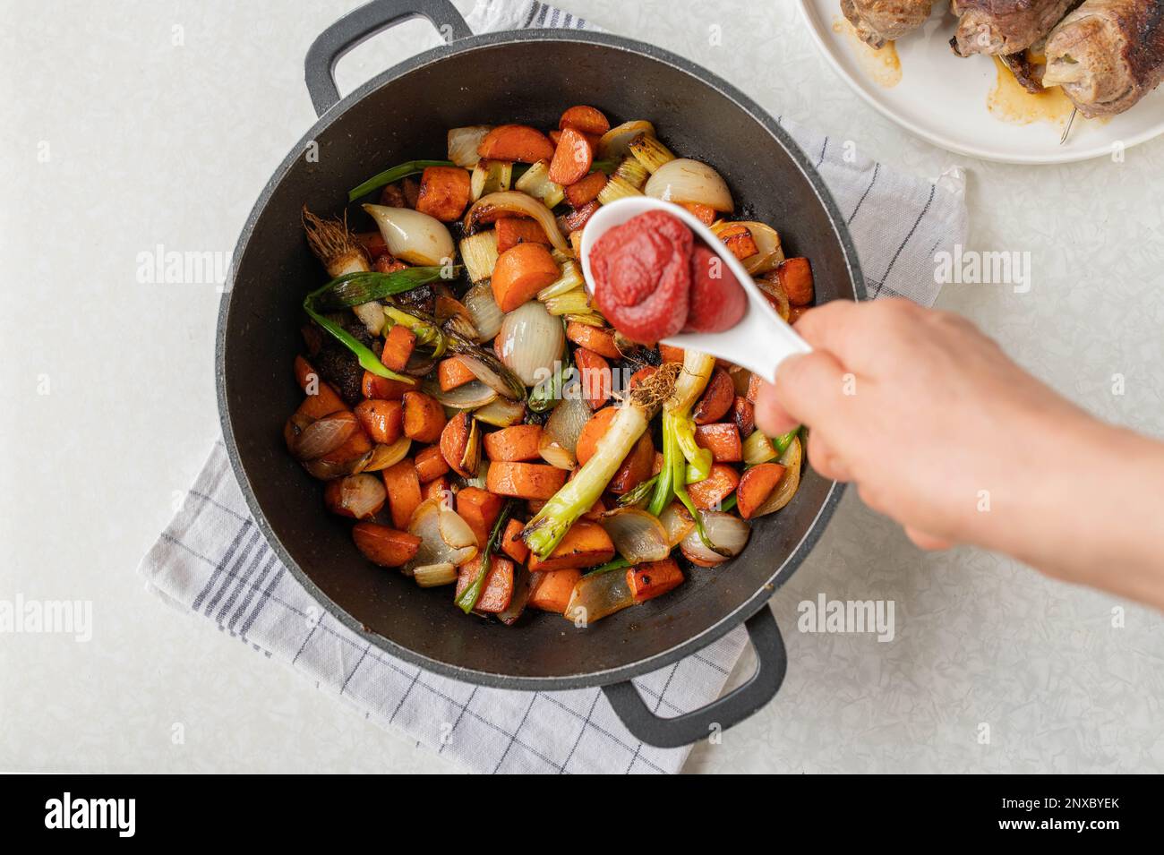 Put tomato paste in a sauce pan with chopped and roasted vegetables for