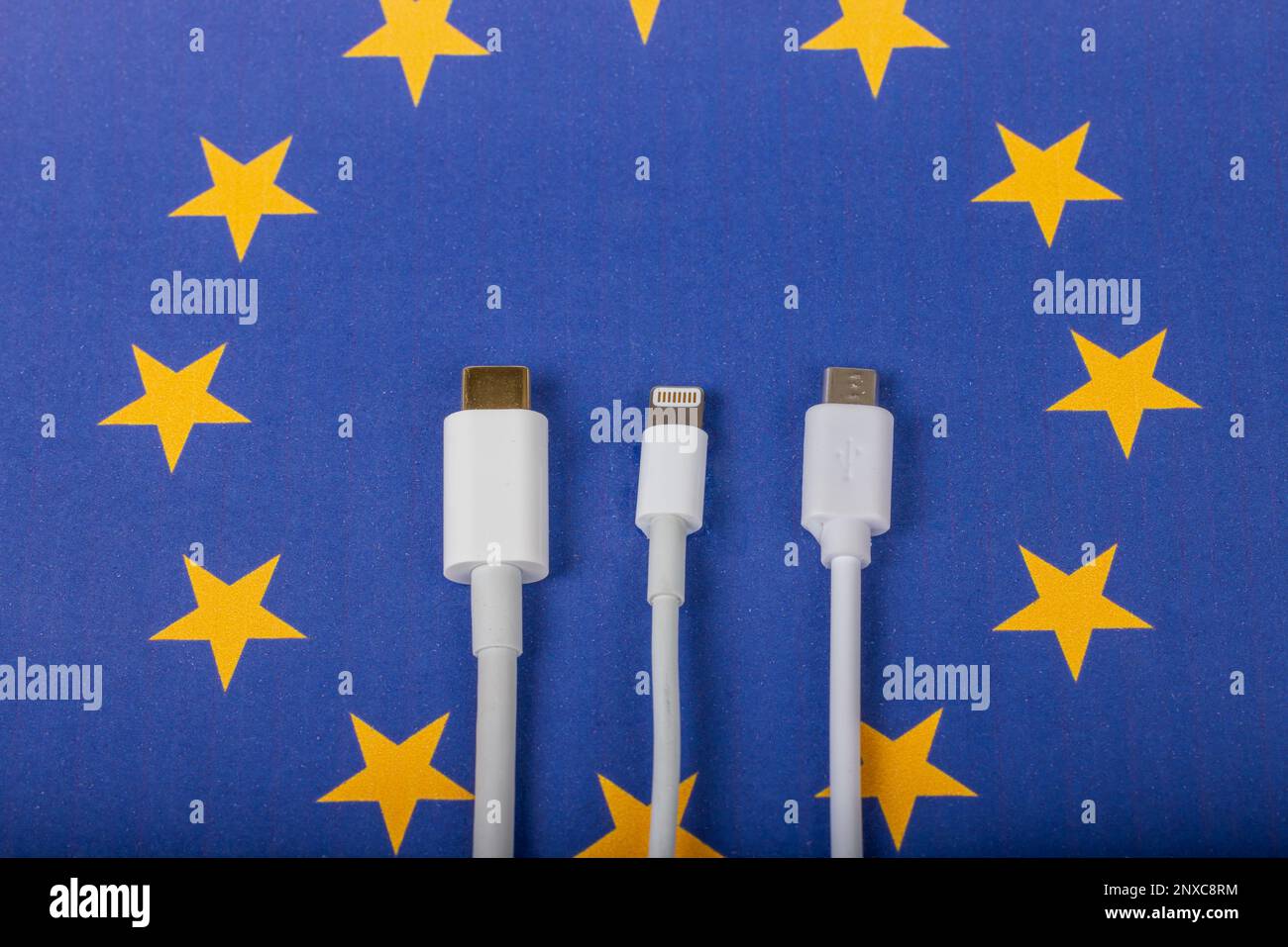 Concept for EU law to force USB-C chargers for all phones. EUROPEAN UNION flag and USBC universal charging cable as a standard for small electronic de Stock Photo