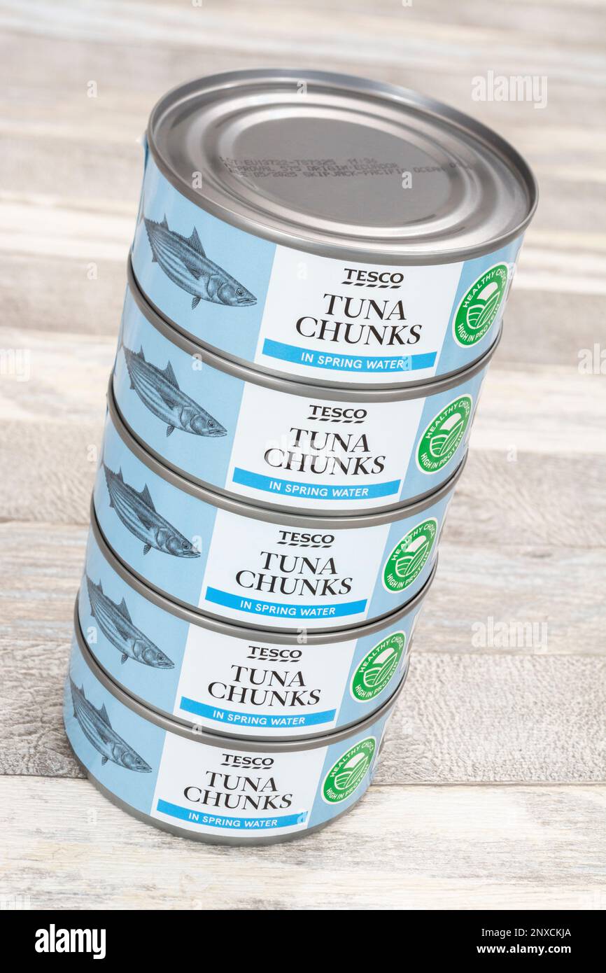 Cans of tinned Tesco Tuna chunks on a kitchen table. For UK food shortages, healthy foods, Stock Photo