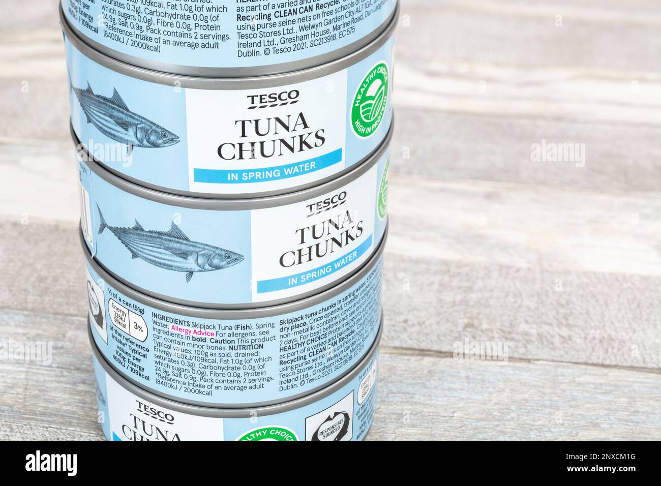Cans of tinned Tesco Tuna chunks on a kitchen table. For UK food