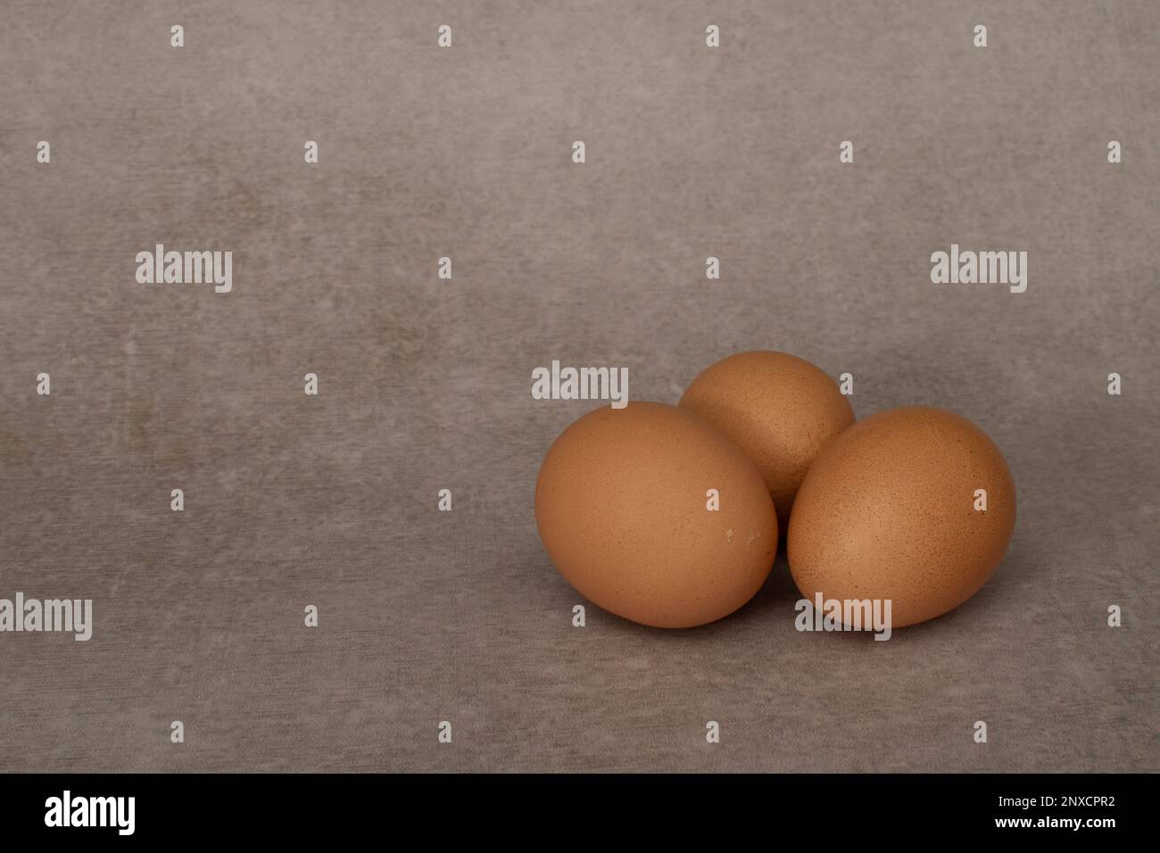 Three eggs isolated on gray background Stock Photo