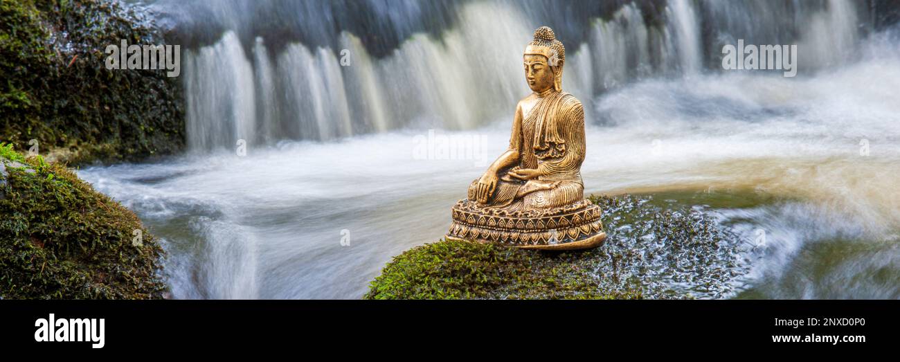 Buddha sculpture sitting in flowing water Stock Photo
