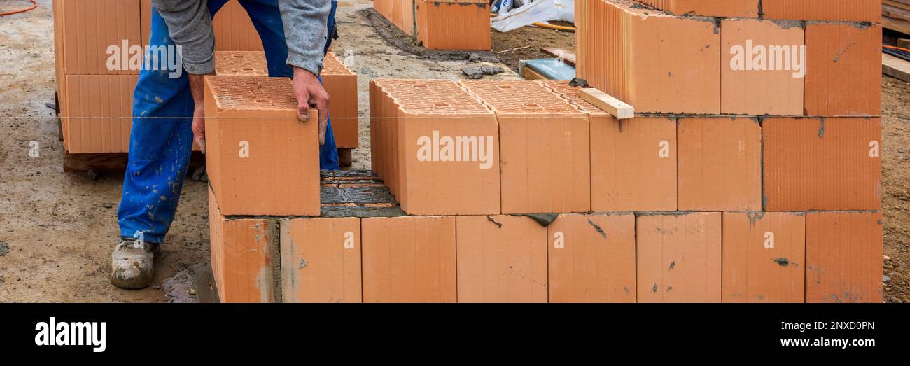 bricklayer at work at new house in construction Stock Photo