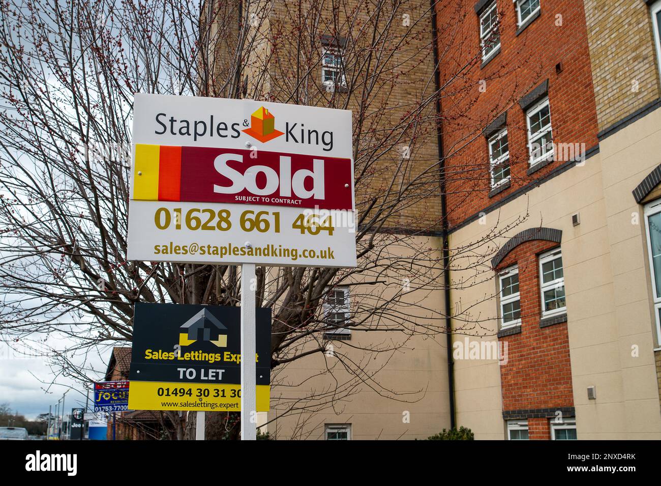Slough, Berkshire, UK. 1st March, 2023. A sold sign outside a block of apartments in Slough, Berkshire. The Nationwide Building Society House Price Index has reported that the price of houses dropped in value by 1.1% year on year during February. Although properties are still being sold, some sellers are having to reduce the price of their homes by on average £14,000. Credit: Maureen McLean/Alamy Live News Stock Photo