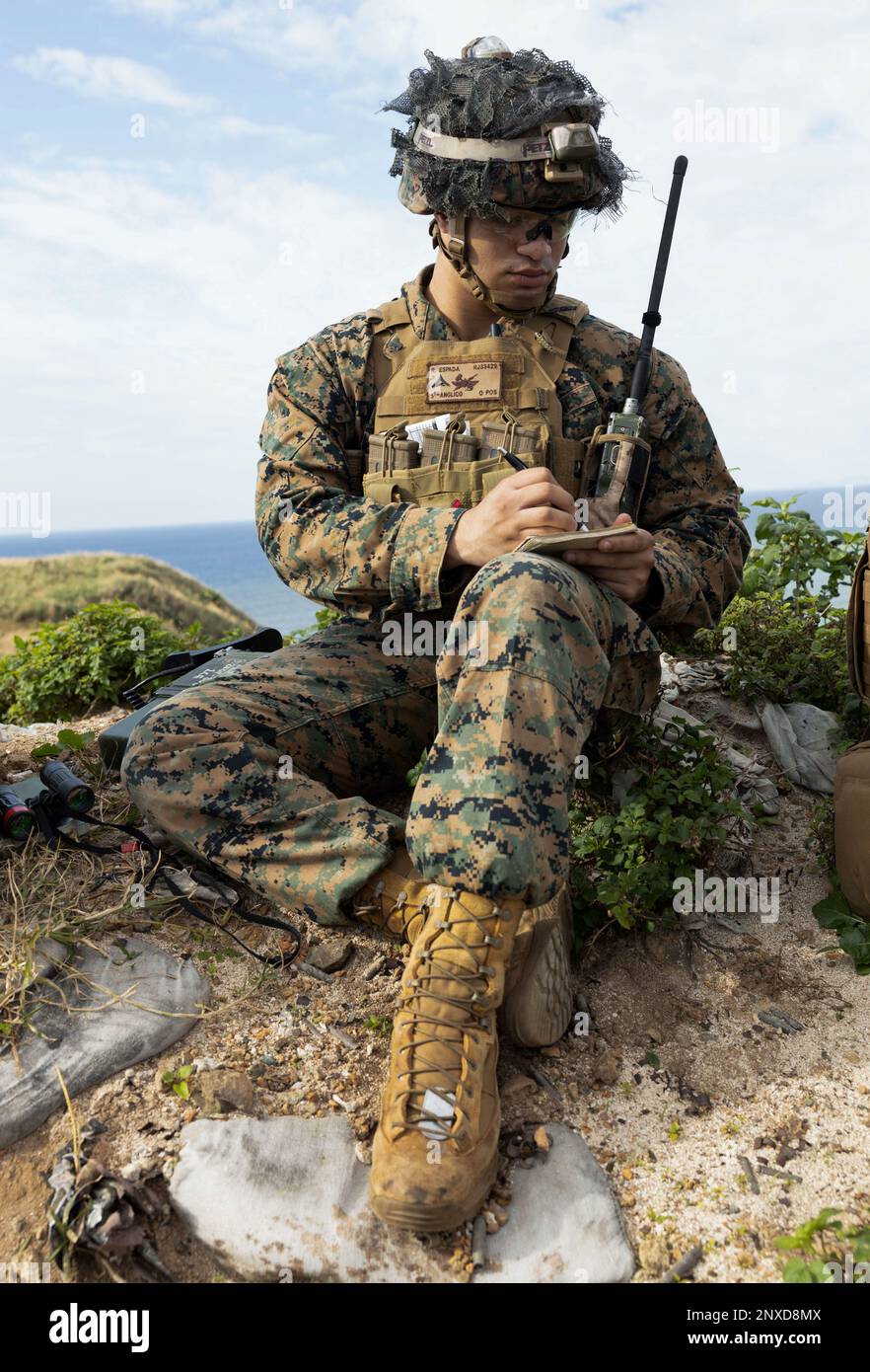 U.S. Marine Corps Lance Cpl. Ricardo Espada, a fire support Marine with 5th Air Naval Gunfire Liaison Company, command element, 31st Marine Expeditionary Unit, plots target data during a tactical air control party at W-174 Live Fire Range, Okinawa, Japan, Jan. 10, 2023. The training provided an opportunity to work in a dynamic tactical situation and refine target plotting skills. The 31st MEU, the Marine Corps’s only continuously forward- deployed MEU, provides a flexible and lethal force ready to perform a wide range of military operations as the premiere crisis response force in the Indo-Pac Stock Photo