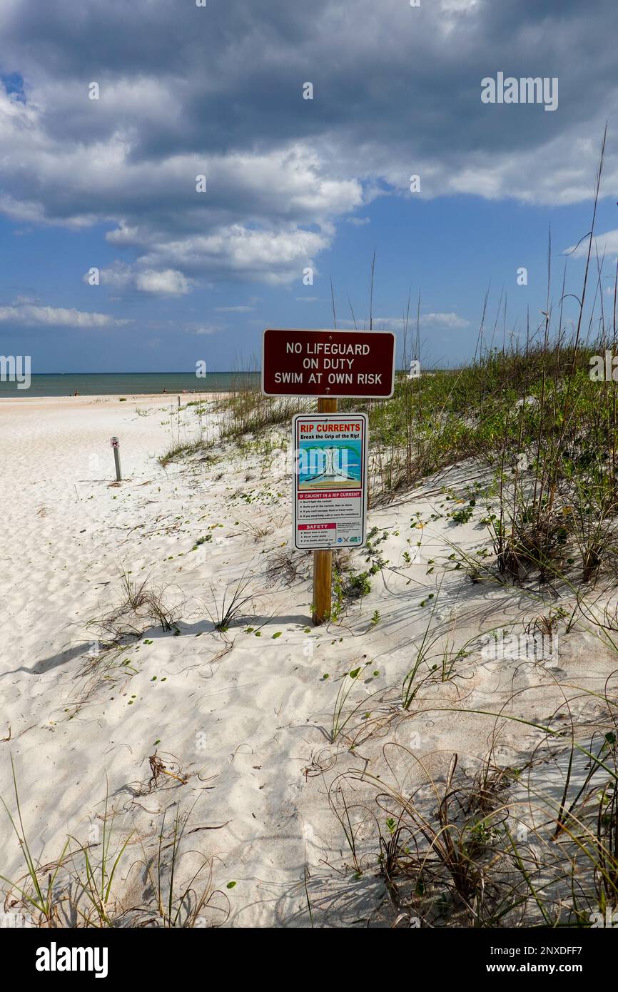 Signs on beach, rip currents, no lifeguard, at Anastasia State Park, St. Augustine Beach, Florida, USA. Stock Photo