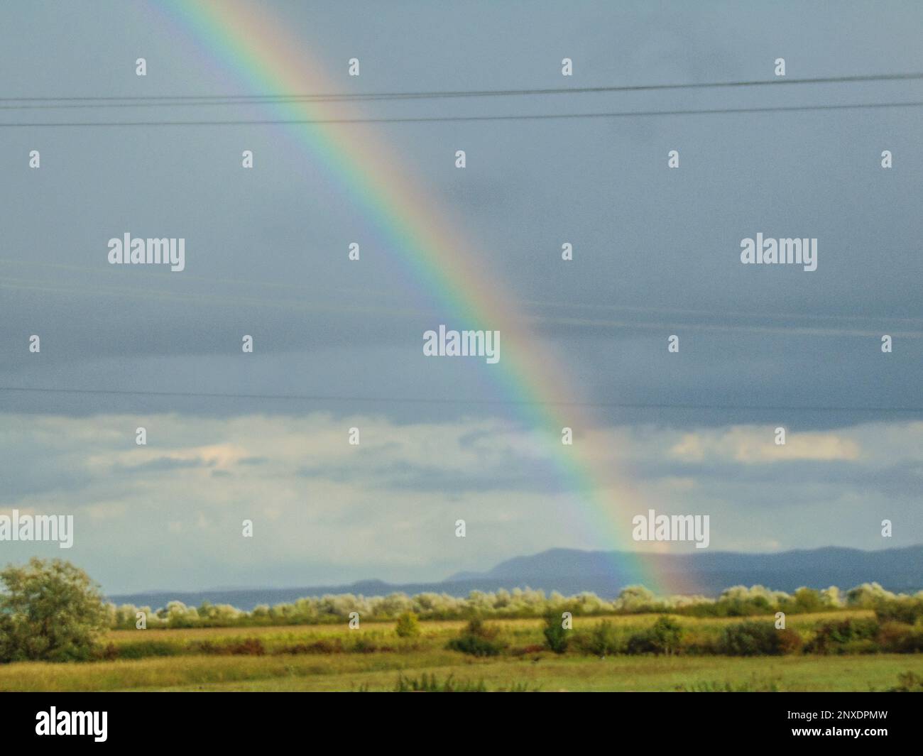 Rainbow after the rain in Maramures county, Romania Stock Photo - Alamy