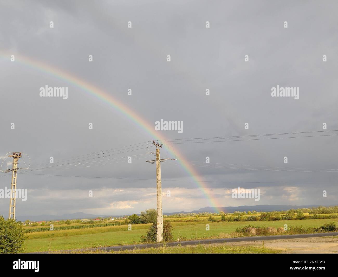 Rainbow after the rain in Maramures county, Romania Stock Photo - Alamy