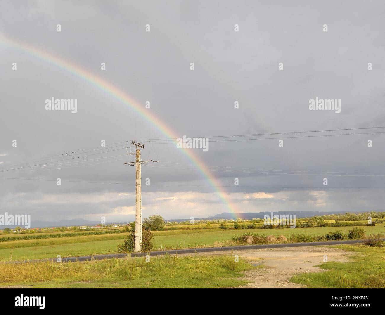 Rainbow after the rain in Maramures county, Romania Stock Photo - Alamy