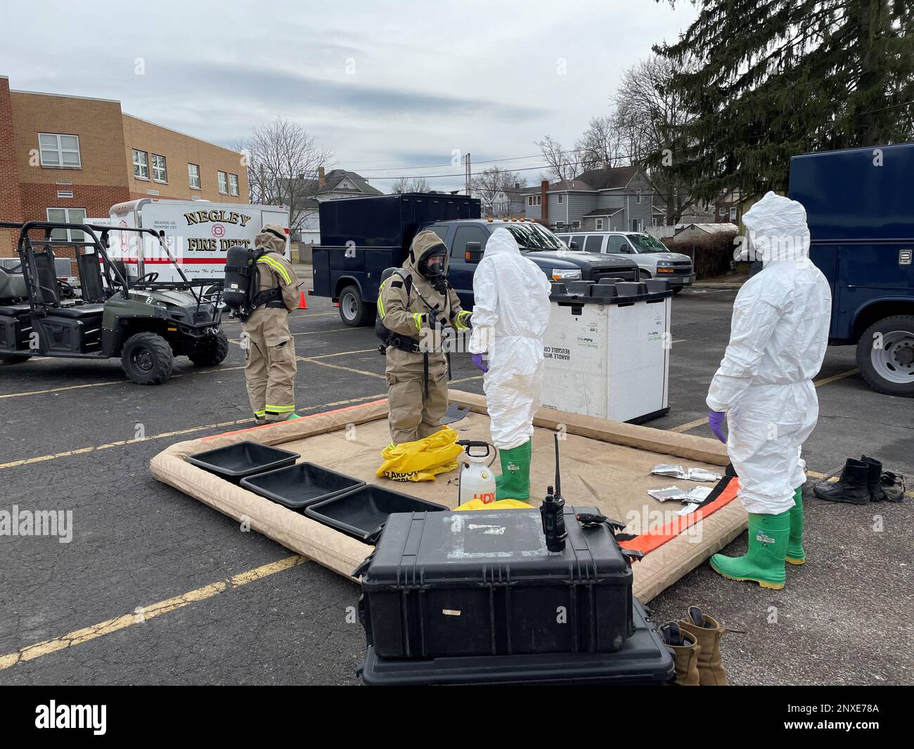 Members of the Ohio National Guard’s 52nd Civil Support Team prepare to enter an incident area to assess and monitor public facilities for any potential remaining hazards with a lightweight inflatable decontamination system (LIDS) in East Palestine, Ohio, Feb. 7, 2023. The LIDS is used to contain any potential contamination that might occur within an incident area following a site assessment. The 52nd CST is supporting local and state authorities with incident assessments and monitoring of hazardous material following a Feb. 3 train derailment in East Palestine. Stock Photo