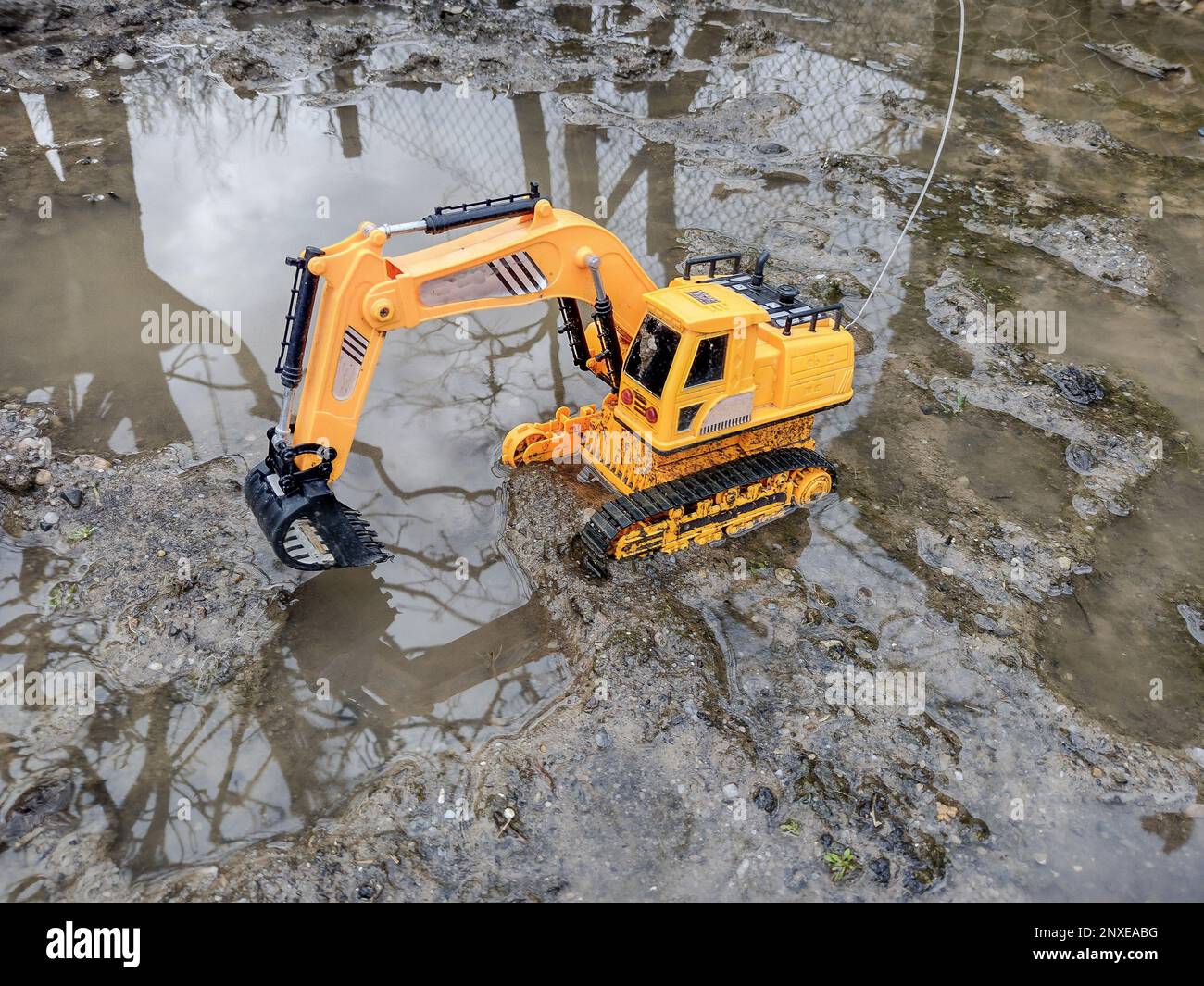 Toy excavator in the mud Stock Photo Alamy