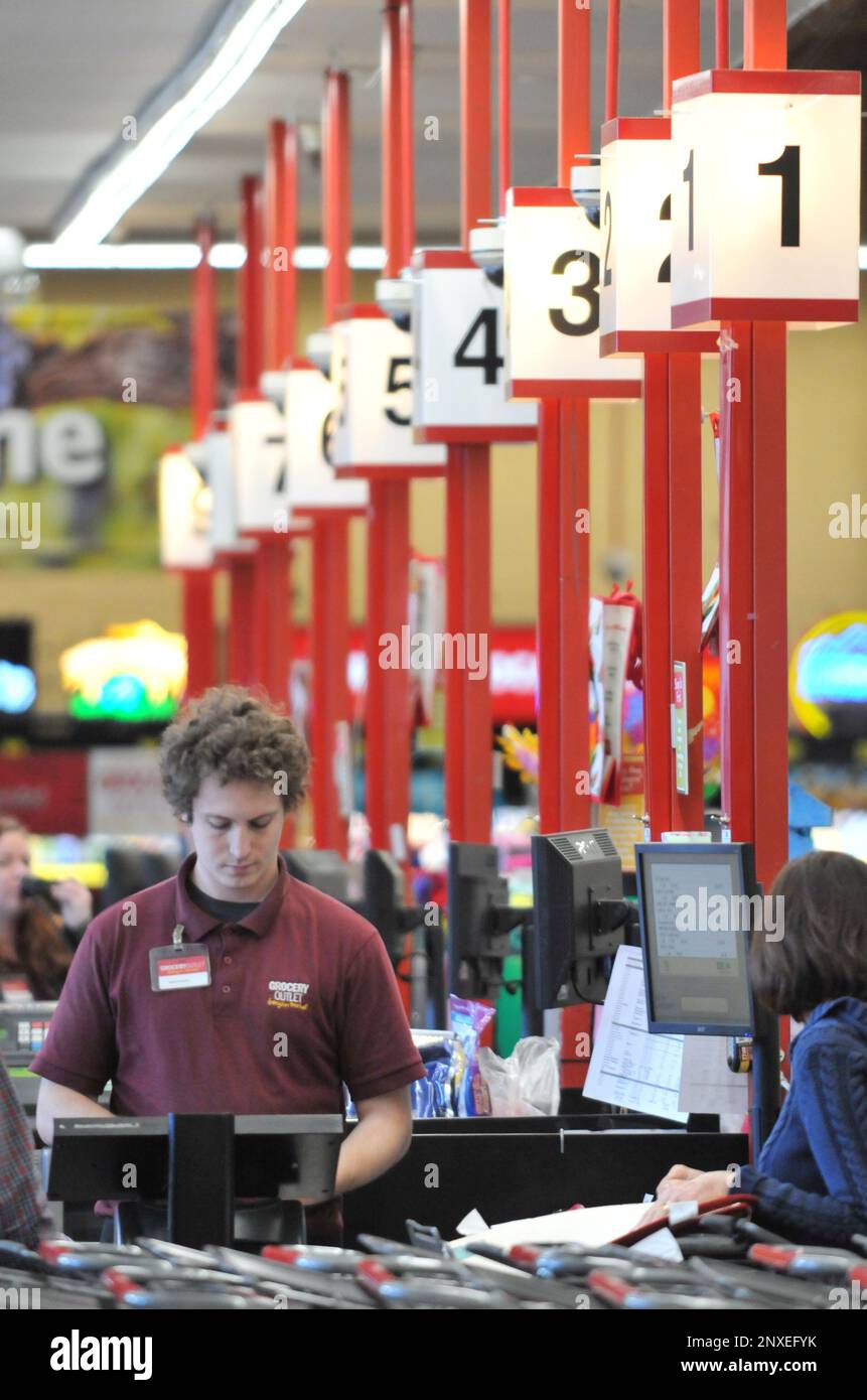 Grocery Outlet cashier Michael Foppiano assists a customer at the Grass Valley store off of