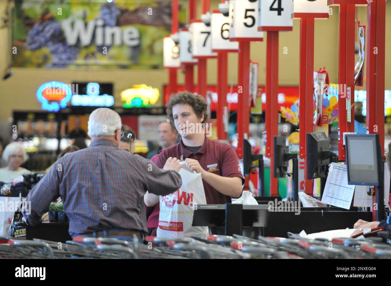 Grocery Outlet cashier Michael Foppiano assists a customer at the Grass Valley store off of