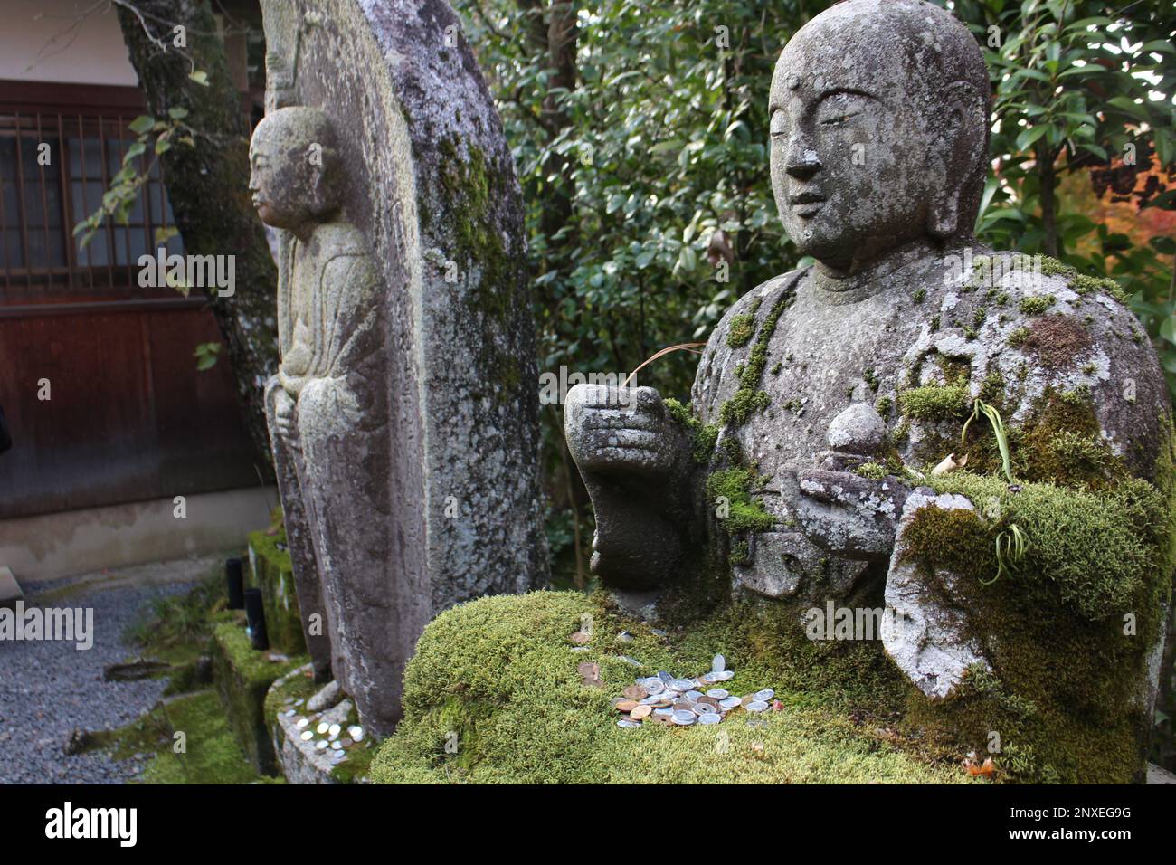 Stone statues covered by moss in the garden of Eikando temple, Kyoto