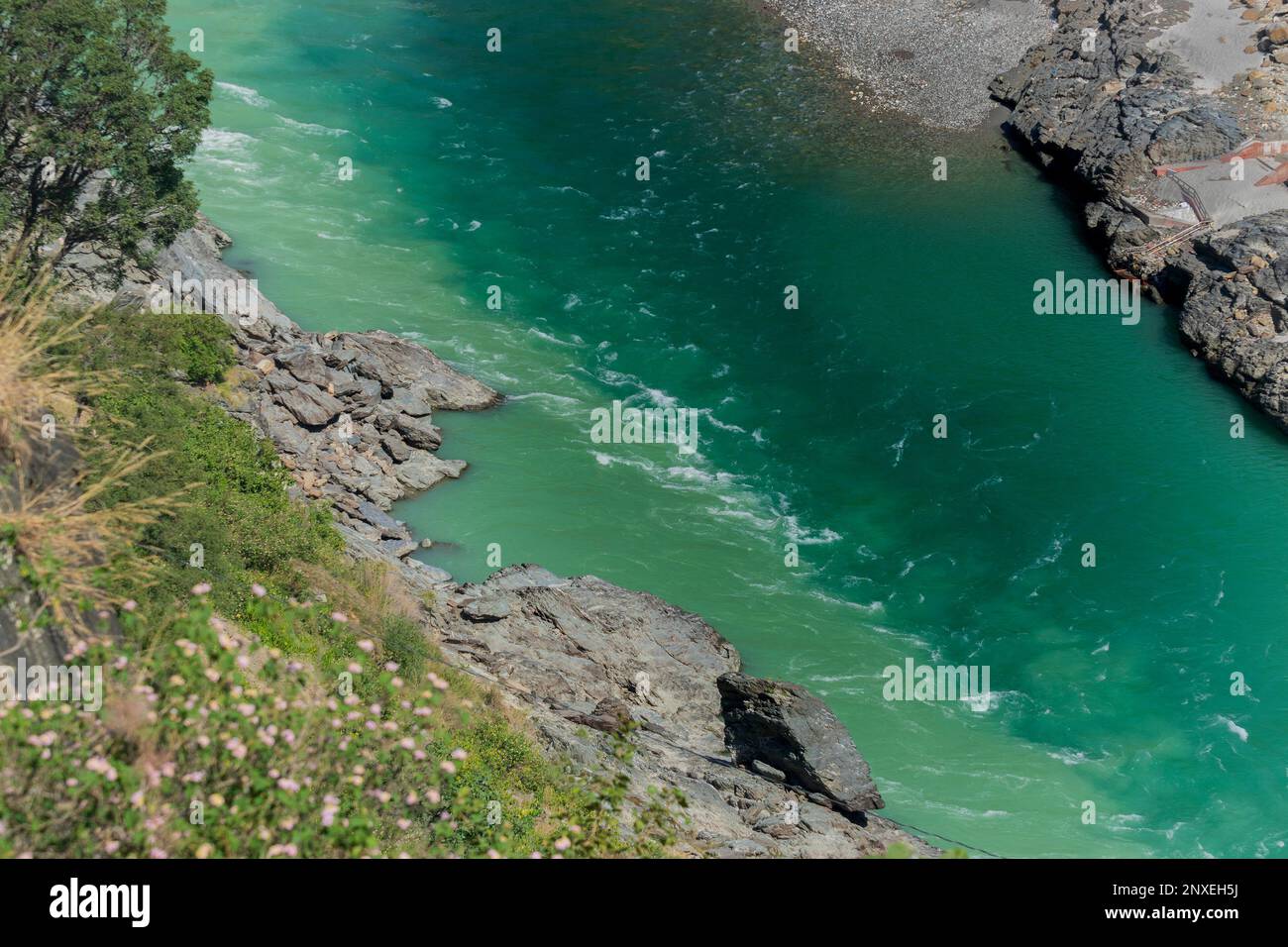 Bhagirathi river from left side and Alakananda river with turquoise blue colour from right side converge at Devprayag,Holy conflunece,Himalays, India. Stock Photo