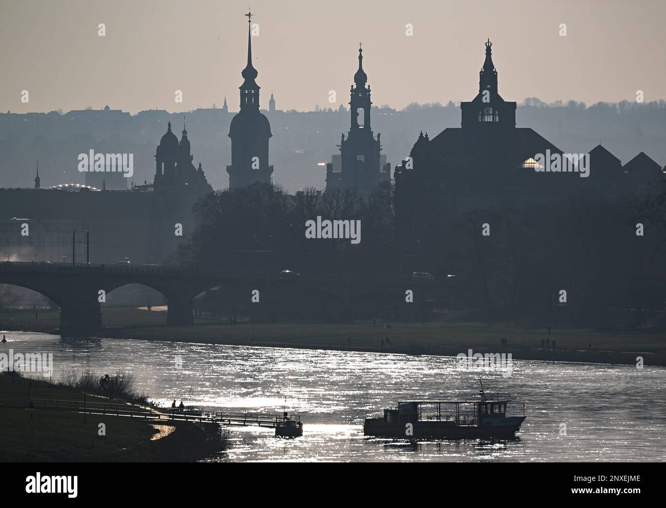 Dresden, Germany. 01st Mar, 2023. A ferry of the Dresdner Verkehrsbetriebe (DVB) crosses the Elbe from the Johannstadt district in the afternoon. In the background you can see the old town with the Ständehaus, the Hausmannsturm, the Hofkirche and the State Chancellery on the Neustadt side. Credit: Robert Michael/dpa/Alamy Live News Stock Photo