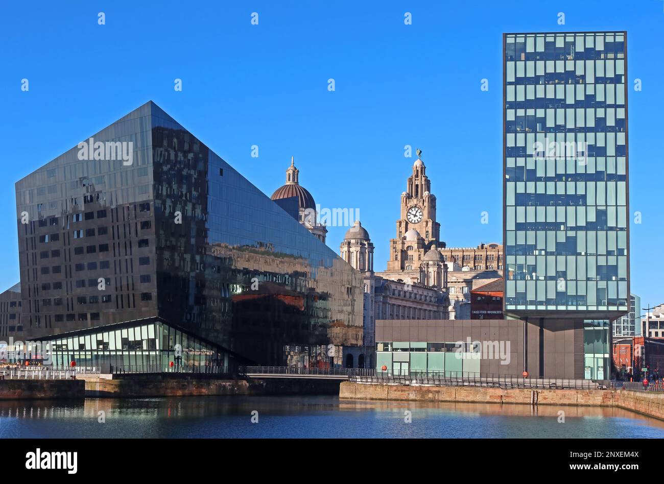 The Pier Head three graces, dwarfed by modern buildings, Mann Island office block and black Longitude Building apartments & Open Eye gallery Stock Photo