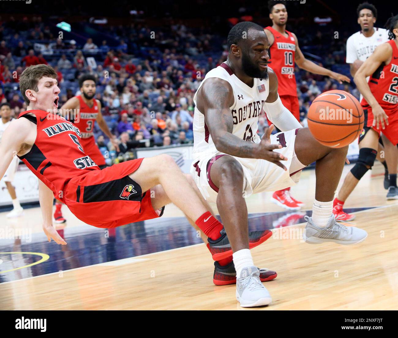 Southern Illinois guard Sean Lloyd, front right, is fouled by Illinois  State guard Matt Hein, left, as they collide in the second half of an NCAA  college basketball game in the semifinals
