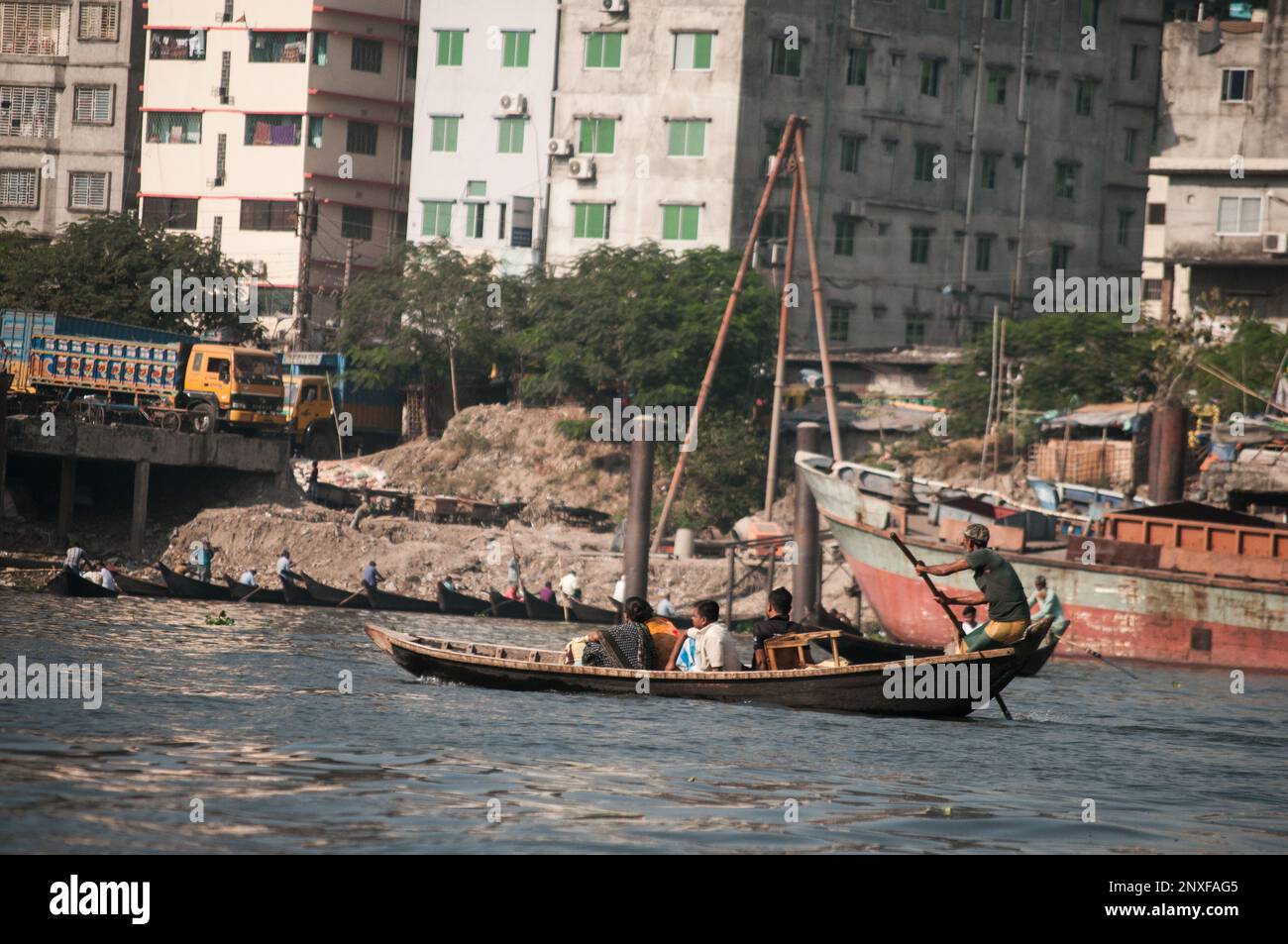 Picture of Boat on the water in Sadarghat and roadside view. Some flower sellers in Dhaka, Bangladesh Stock Photo