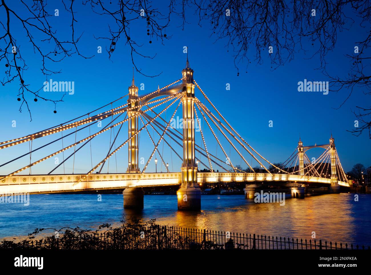 Albert Bridge illuminated at dusk, London, England, GB Stock Photo