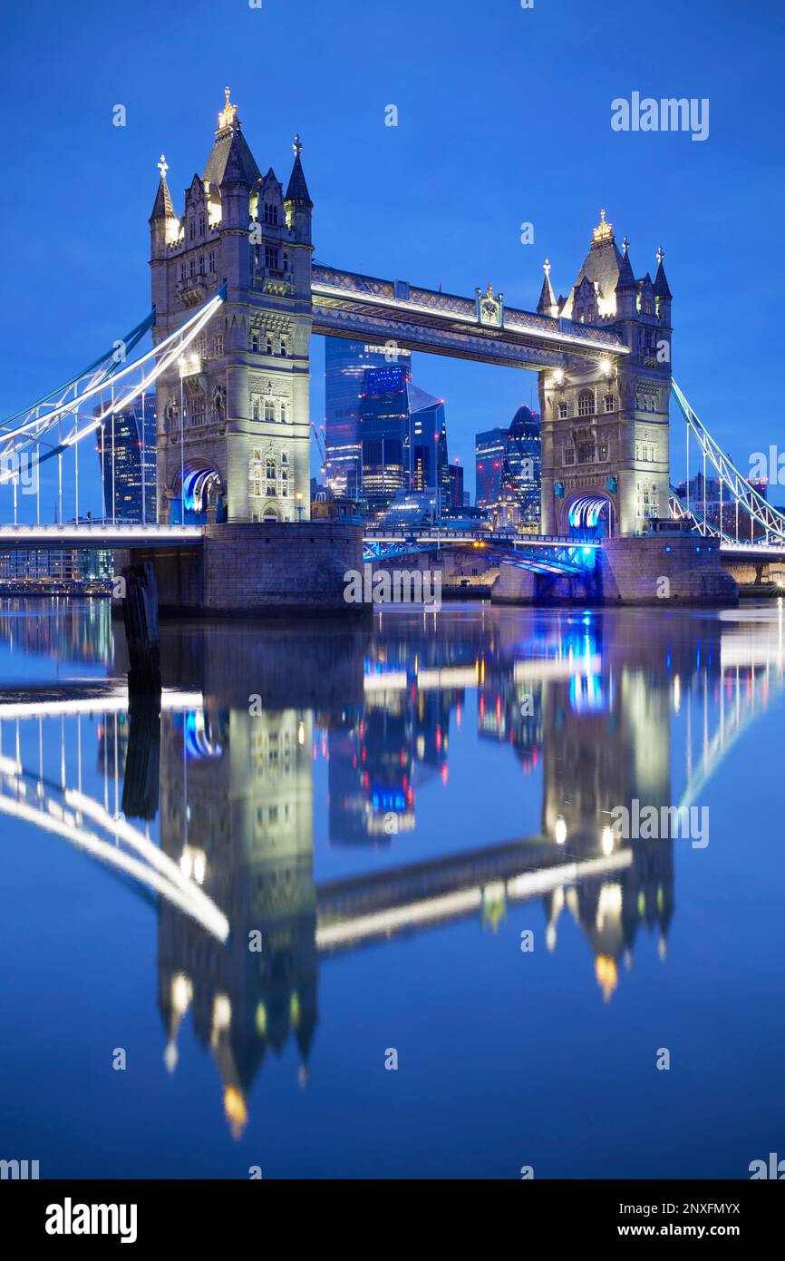 Tower Bridge and London skyline illuminated at night over the  River Thames, London, England, GB Stock Photo