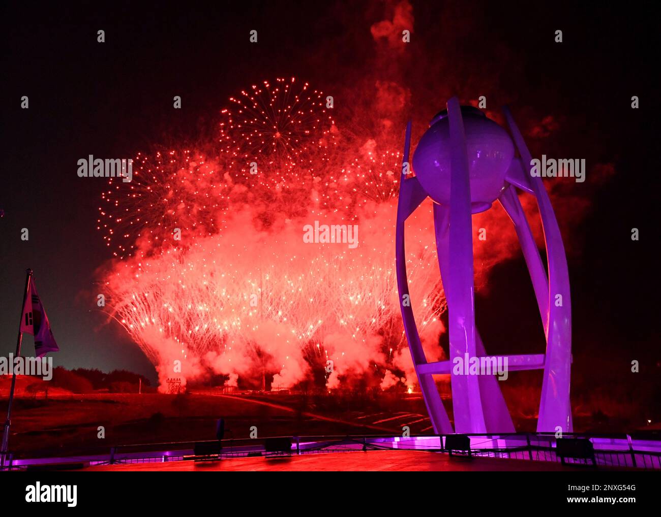 Fireworks explode near the Olympic cauldron at the end of the closing ...