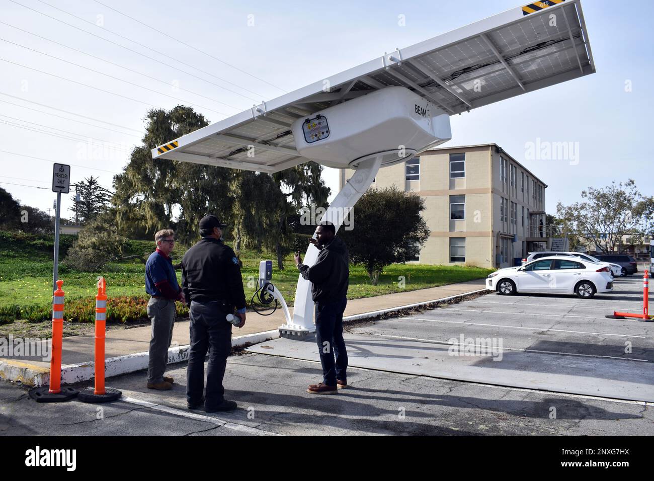 JeDarrin Thompson, right, a contractor, trains Rich Thorne, left, energy manager for the U.S. Army Garrison Presidio of Monterey’s Directorate of Public Works, and Ron Rodriguez, an electrician with the City of Seaside, on the garrison’s new solar charger for electric vehicles at Ord Military Community, Calif., Jan. 12. Stock Photo