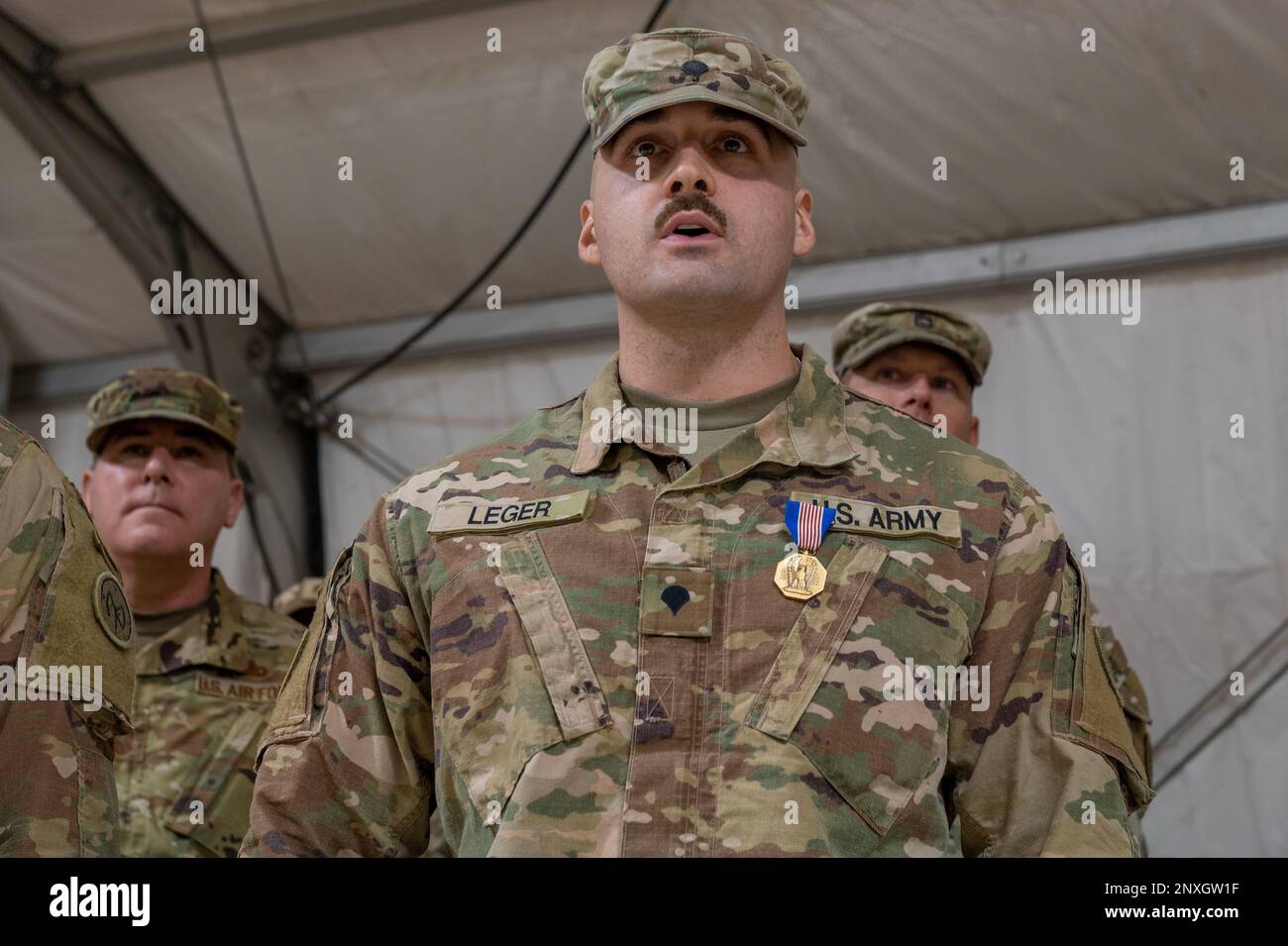 U.S. Army Spc. Ryan Leger, an infantryman of Bravo Co, 182nd Infantry Regiment, Massachusetts Army National Guard delivers remarks after receiving a Soldiers Medal, Jan. 14, 2023, at Prince Sultan Air Base, Kingdom of Saudi Arabia. Leger received the Soldiers Medal for demonstrating bravery and devotion to duty by protecting an individual in need without regard to his own safety, upon witnessing a severe vehicle accident Nov. 7, 2021. Stock Photo