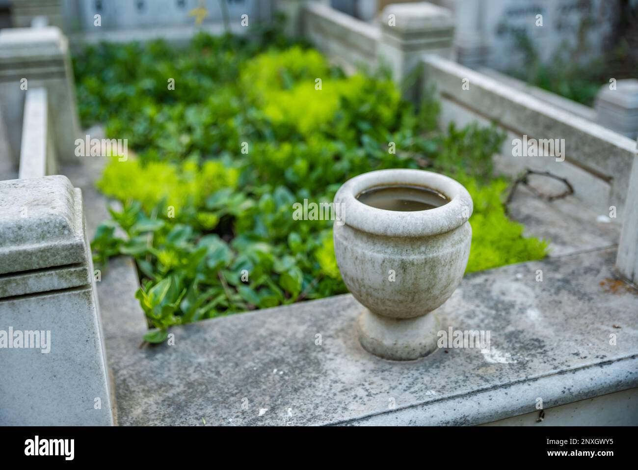 Gravestones and graves at Muslim cemetery. Country cemetery with green