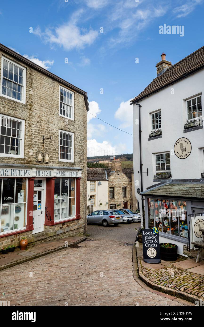 Narrow cobbled street leading off the market place in Alston, the