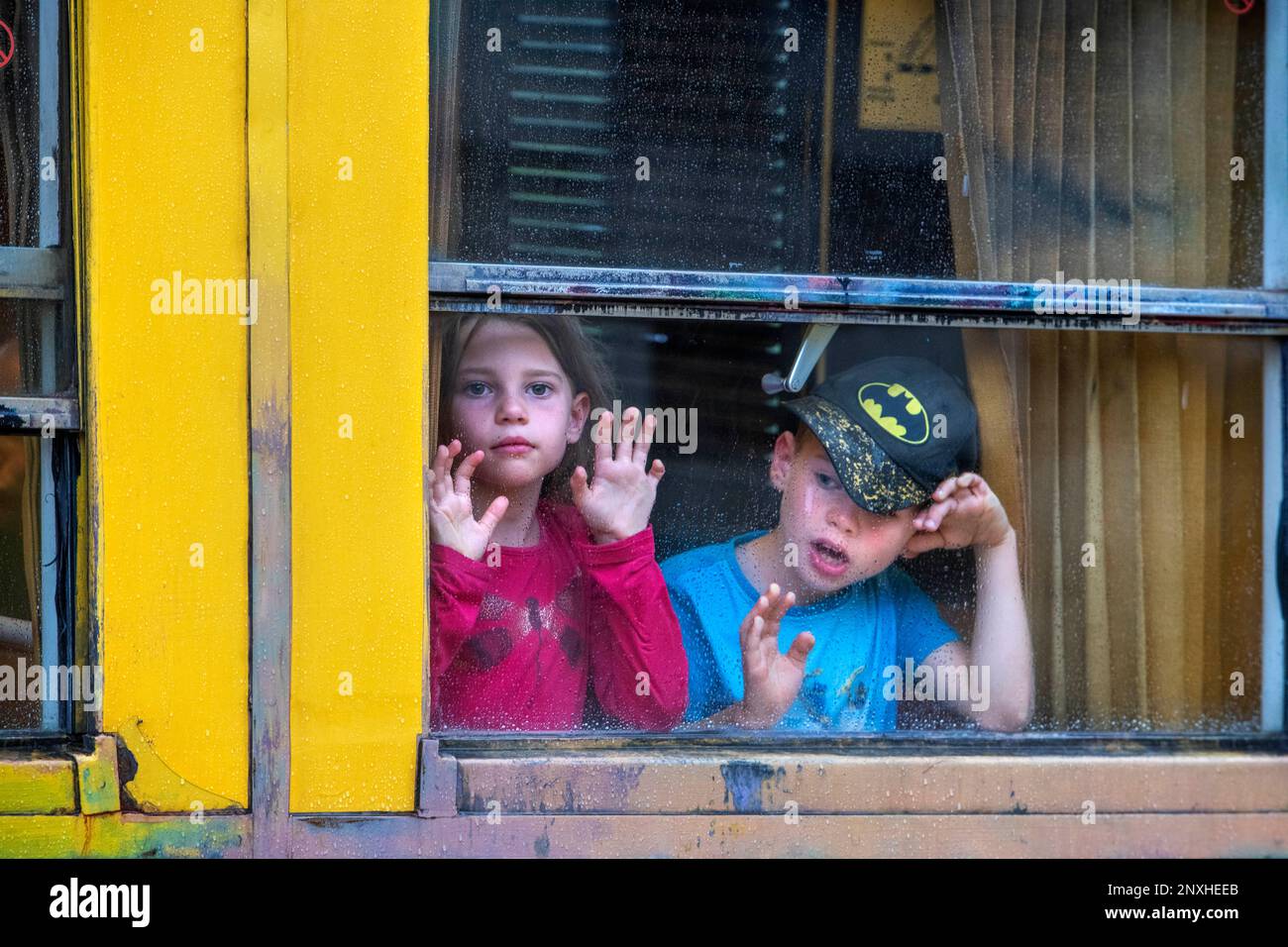 Children looking through the window. The Yellow Train or Train Jaune, Pyrénées-Orientales, Languedoc-Roussillon, France.  The Ligne de Cerdagne, usual Stock Photo