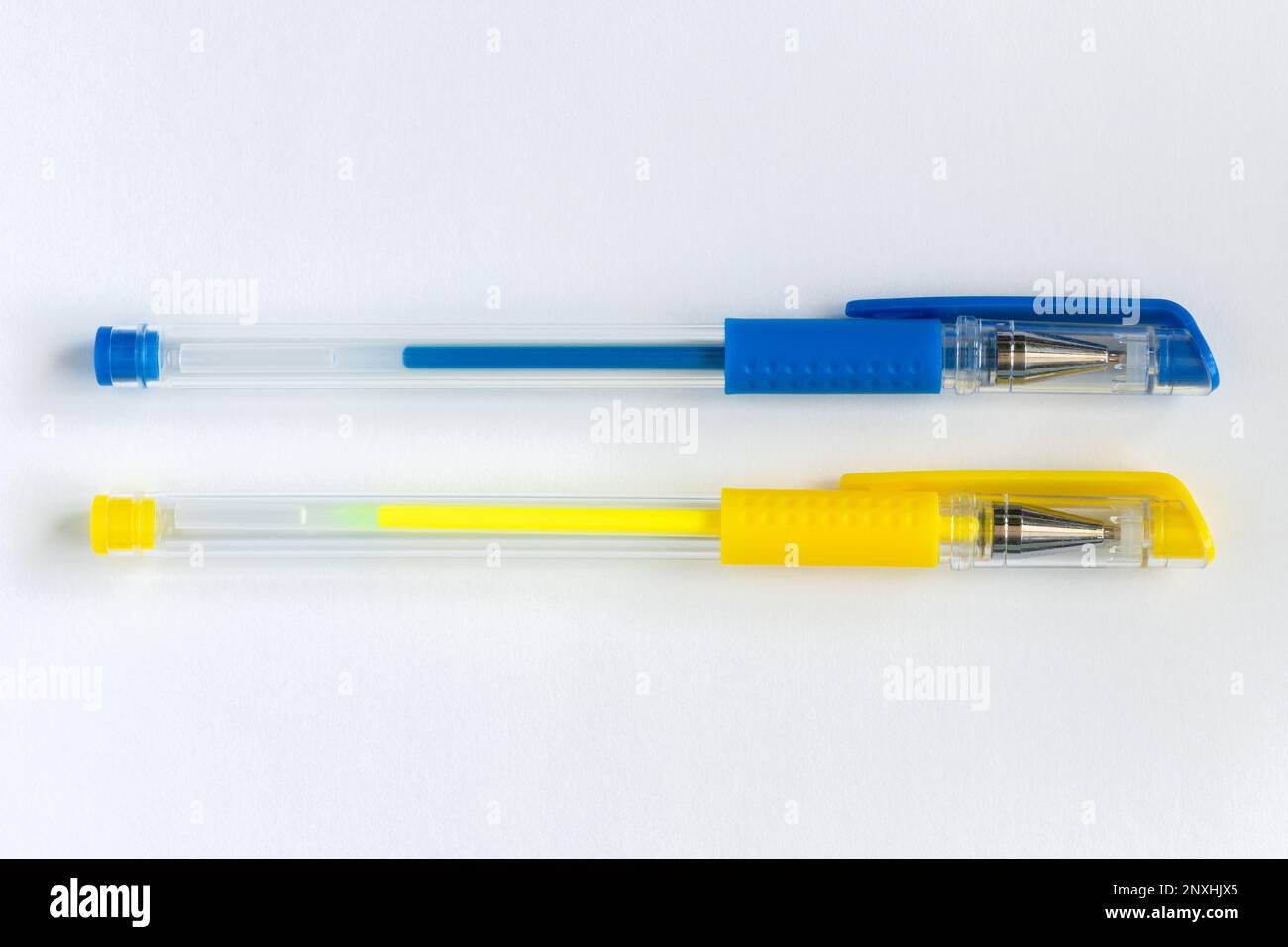 Blue and yellow gel pens on white background Stock Photo Alamy