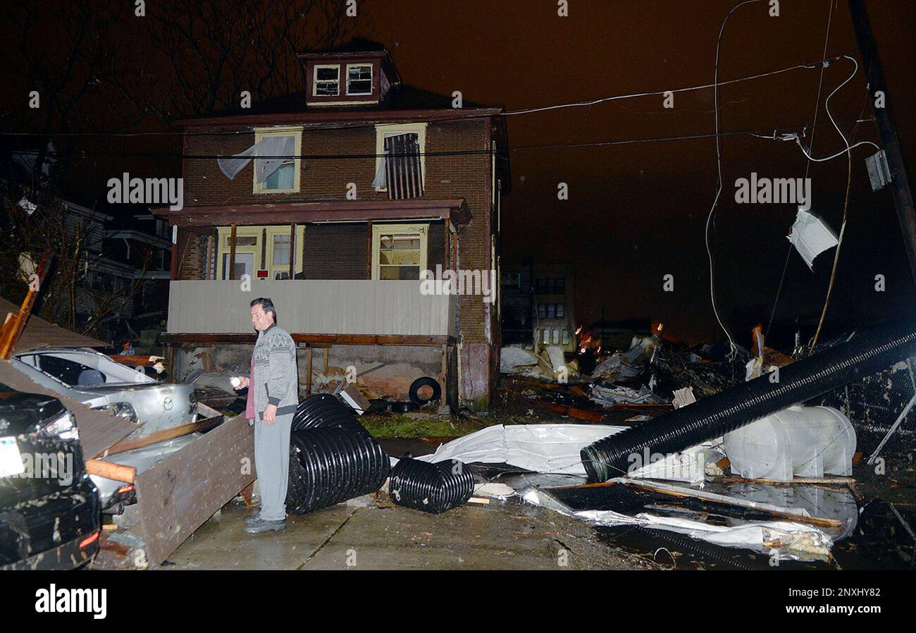Brent Ferris inspects the damage to his home along Gallatin Avenue