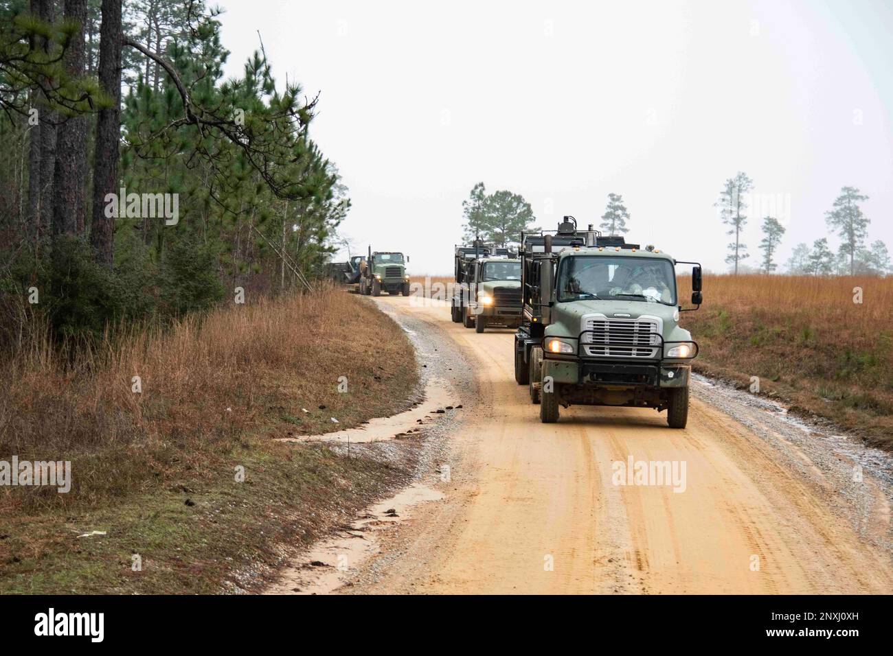 220201-N-PI330-1032 Camp Shelby, Mississippi (February 1, 2023) Seabees, assigned to Naval Mobile Construction Battalion 133 (NMCB 133), move as a convoy during a field training exercise on Camp Shelby, Mississippi, February 1, 2023. NMCB 133 is at Camp Shelby, Mississippi operating as part of Navy Expeditionary Combat Command conducting the advanced phase of the force readiness training plan (FRTP). Stock Photo