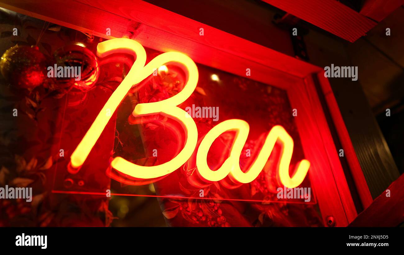 Bar fluorescent sign Light glowing at night in entrance door. Red Bar