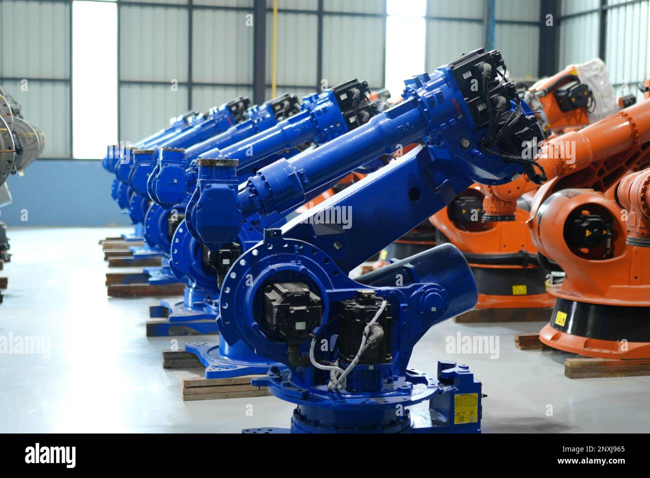 Robotic arm in futuristic assembly manufacturing factory, in factory ...