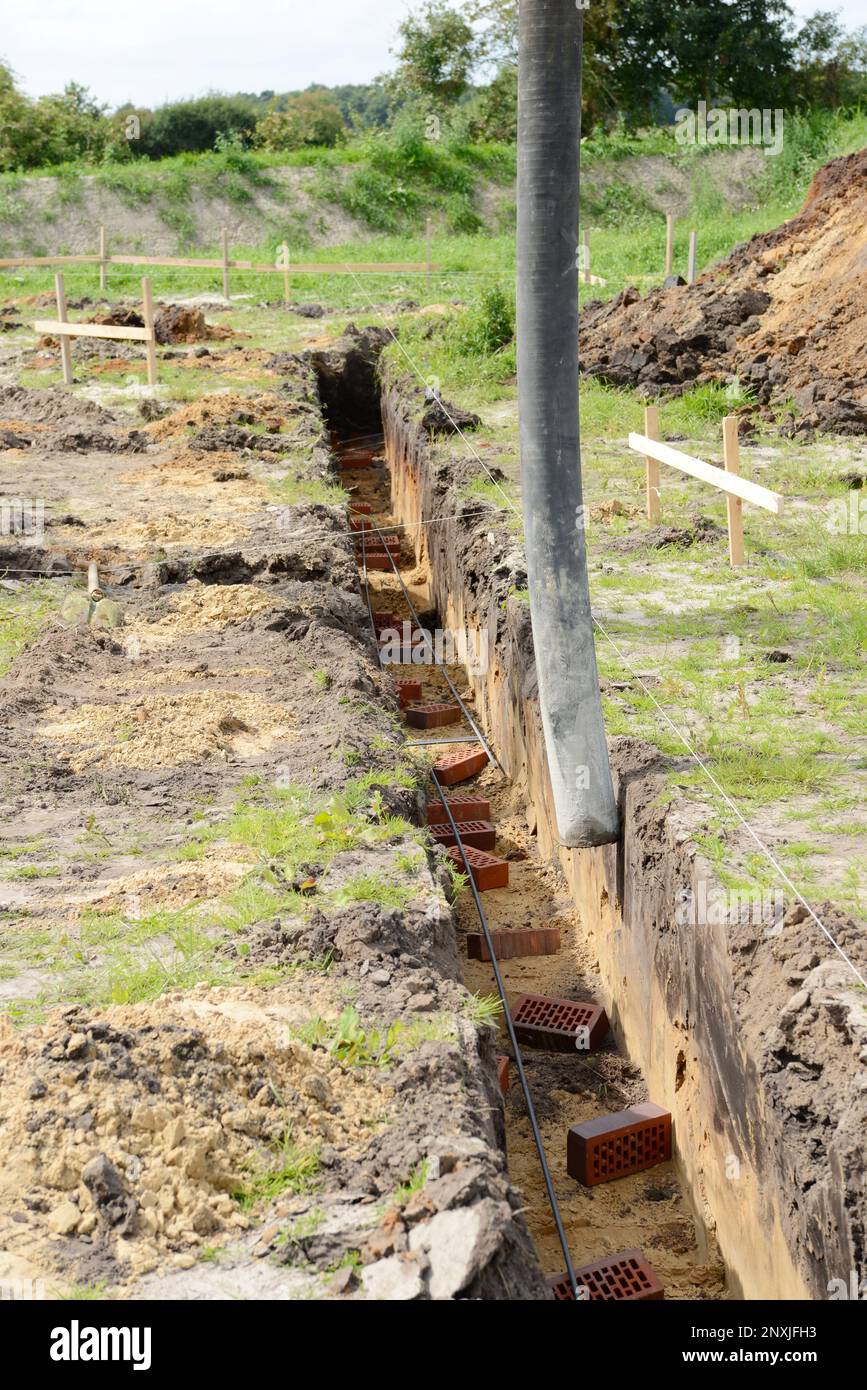 Filling strip foundation with concrete at the construction site. start of building a house. Stock Photo