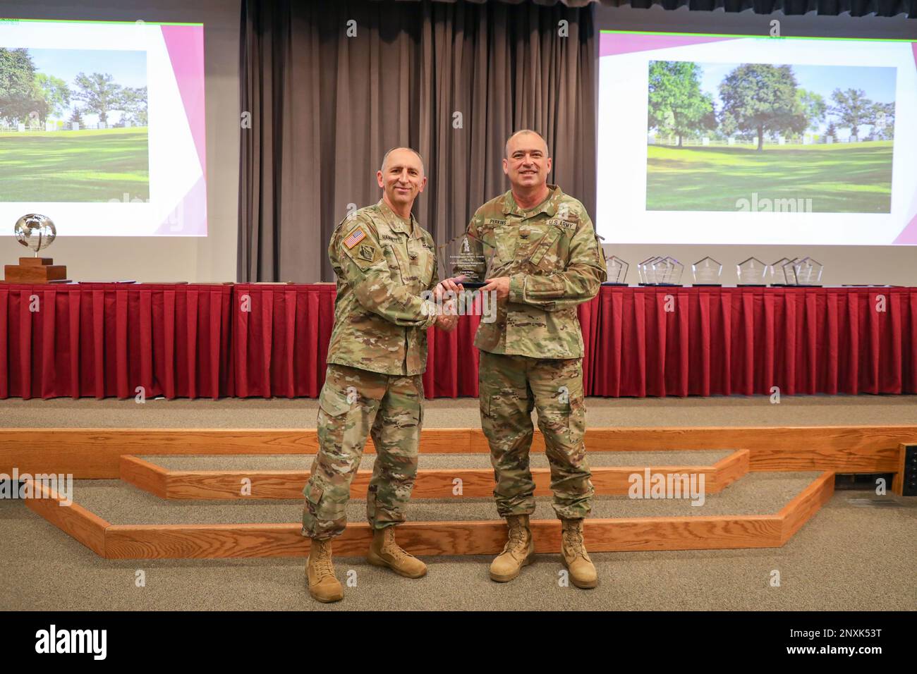 Col. Anthony Hammett, the Army National Guard’s chief of installations, environment and energy, presents the Department of the Army 2021 Cultural Resources Management award (small installation category) to Col. John Perkins, director of the Iowa National Guard Construction and Facilities Management Office, during an awards ceremony at the Professional Education Center at Camp Robinson in North Little Rock, Arkansas, Jan. 24, 2023. The Iowa National Guard CFMO received the national award for its restoration of the historic limestone fence and gatehouse at Camp Dodge in Johnston, Iowa. The award Stock Photo