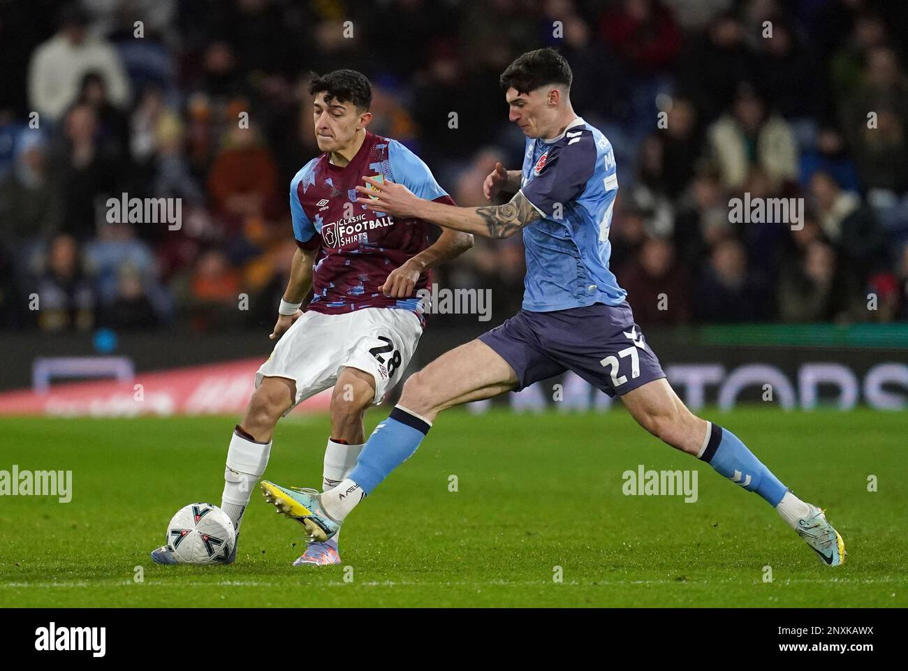 Burnley's Ameen Al-Dakhil (left) and Fleetwood Town's Harvey Macadam battle for the ball during the Emirates FA Cup fifth round match at Turf Moor, Burnley. Picture date: Wednesday March 1, 2023. Stock Photo
