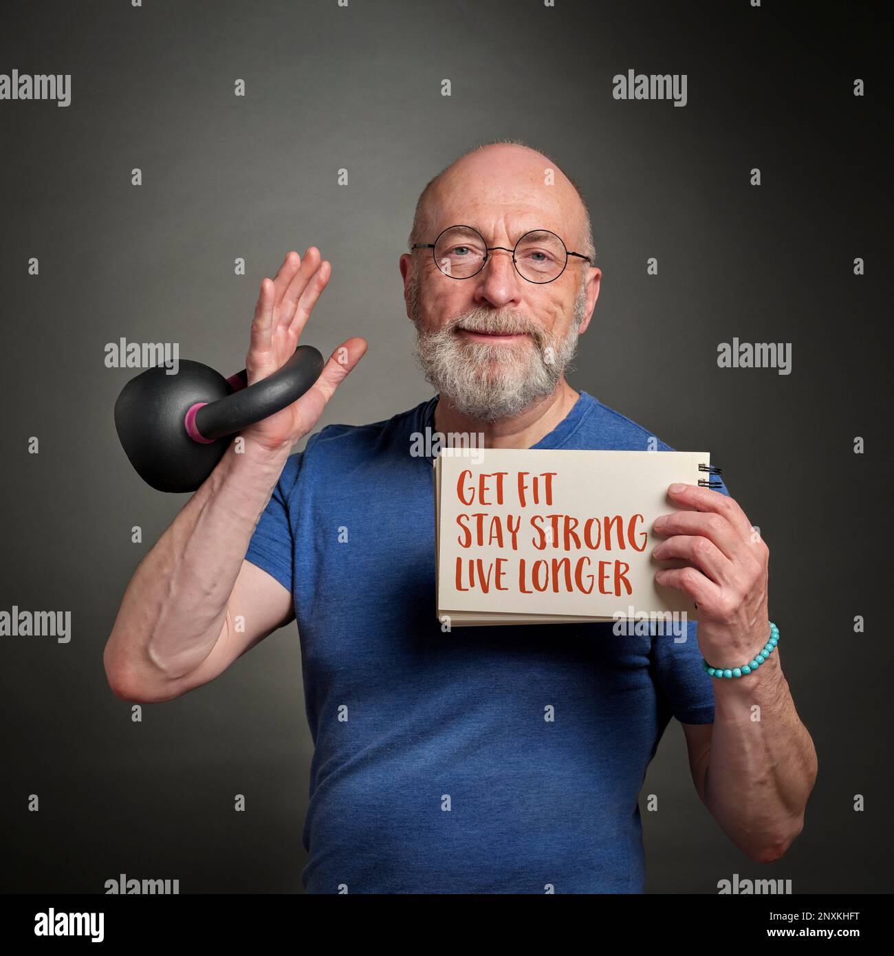 get fit, stay strong, live longer - motivational note held by a senior