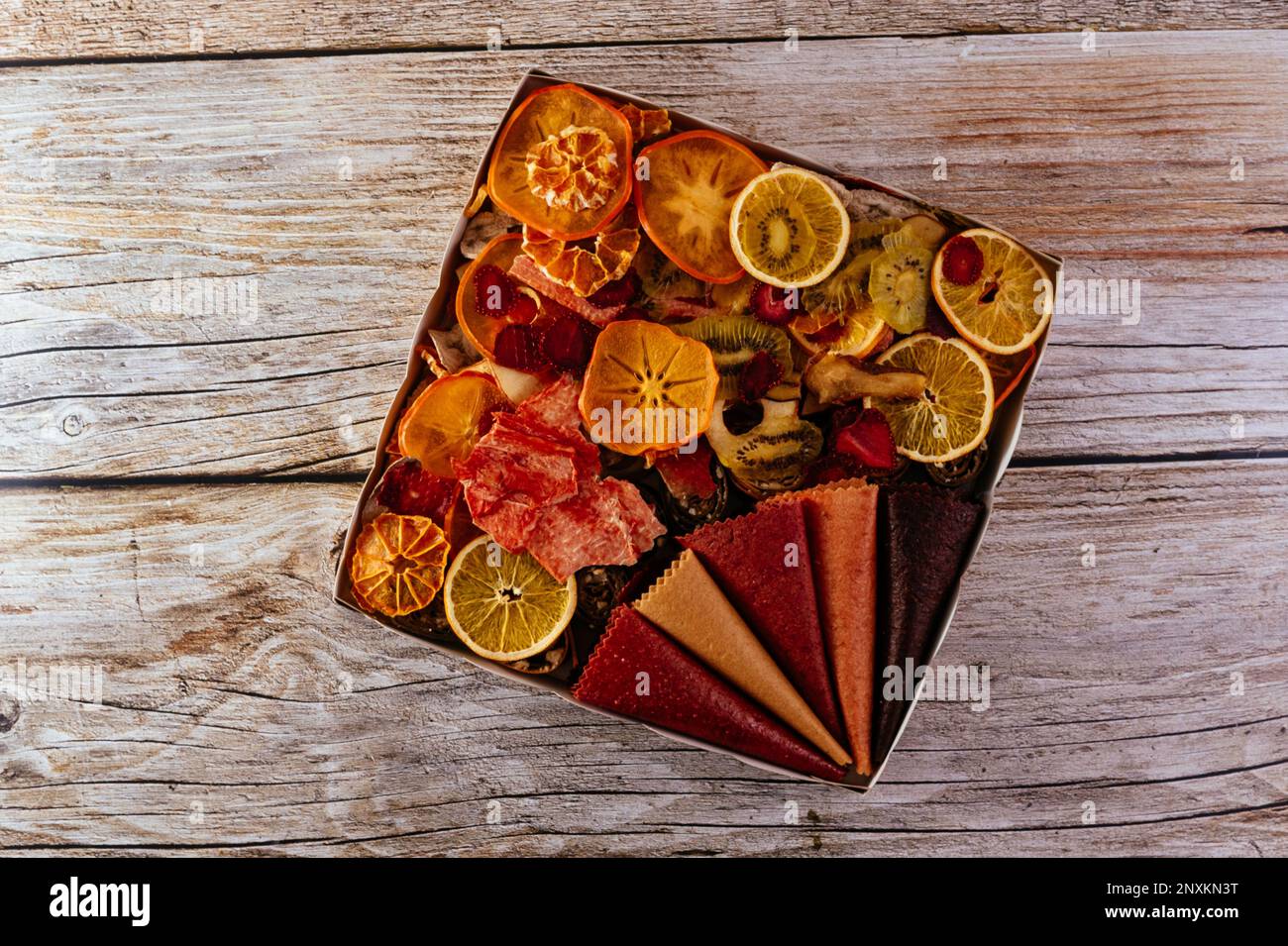 homemade fruit chips. texture. wooden background Stock Photo