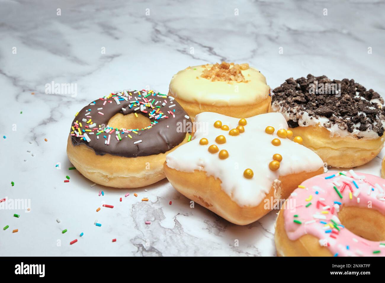 several different donuts on a white background Stock Photo - Alamy