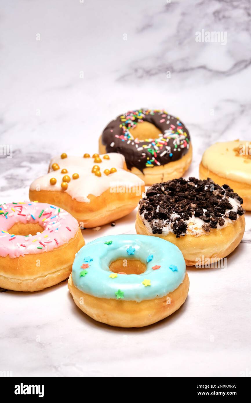 several different donuts on a white background Stock Photo - Alamy