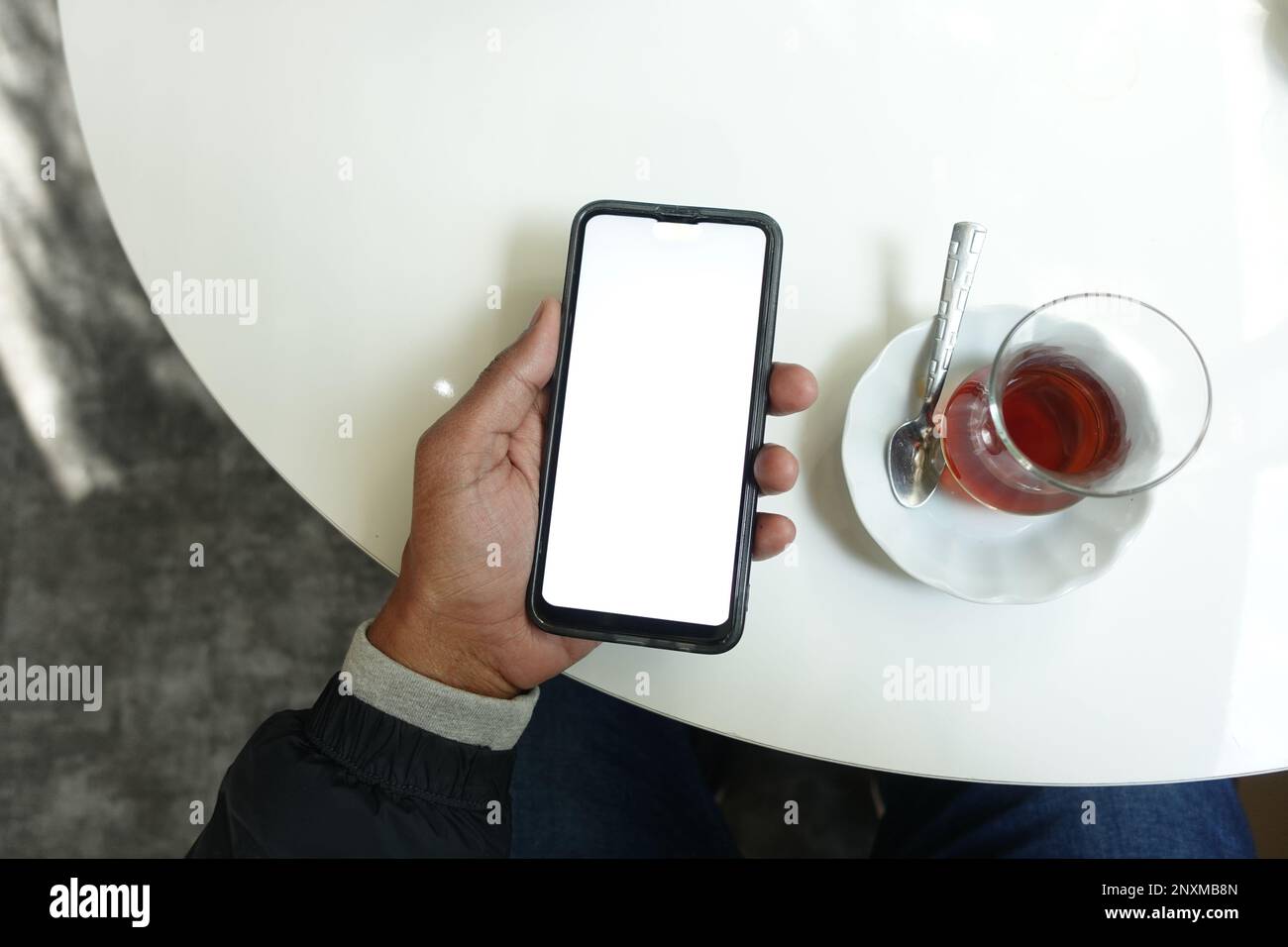 young man hand using smart phone with green screen at cafe Stock Photo ...