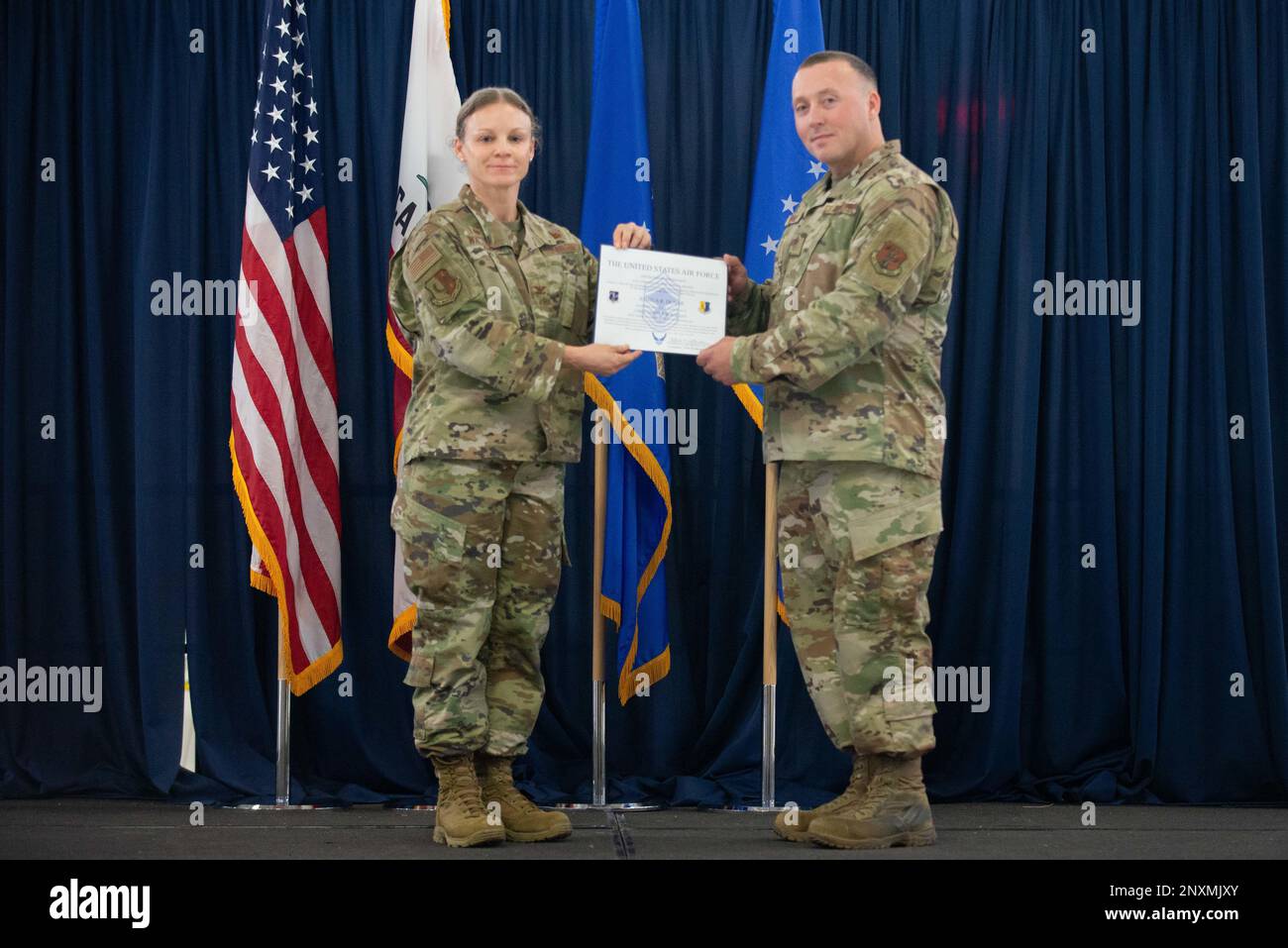 U.S. Air Force Col. Katherine Waterman, 129th Rescue Wing maintenance group commander, promotes Senior Master Sgt. Joshua Dunn to the rank of Chief Master Sergeant at Moffett Federal Airfield, Feb. 4, 2023. Dunne has served in the Air Force for nearly 18 years. (Air National Guard photo by Airman 1st Class Serena Smith) Stock Photo