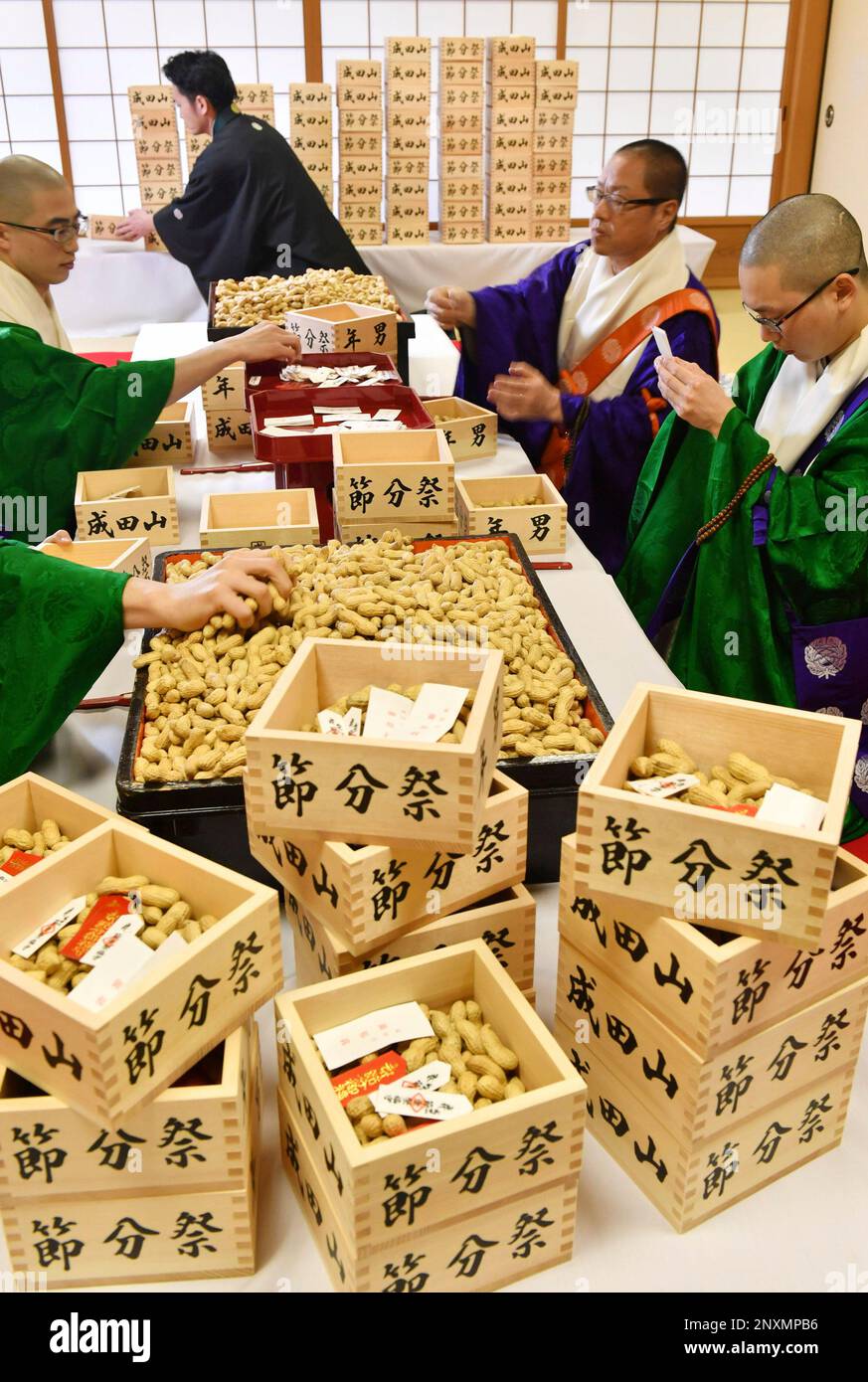 Monks put peanuts in masu, a square wooden measuring cup, prior to the